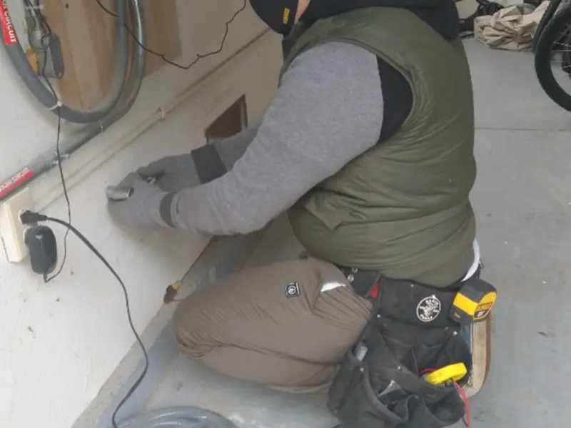 Electrician performing outlet wiring in a Ranchettes garage